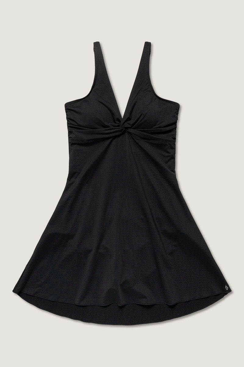 Black swim dress with a tie knot detail on a light gray background